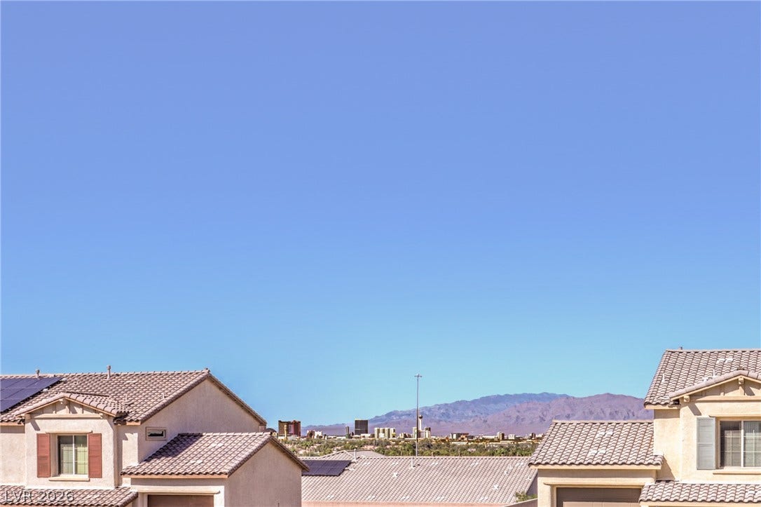 3051 E Serene Avenue, Henderson, NV 89074 Distant mountain ranges and city views frame the surrounding neighborhood rooftops.