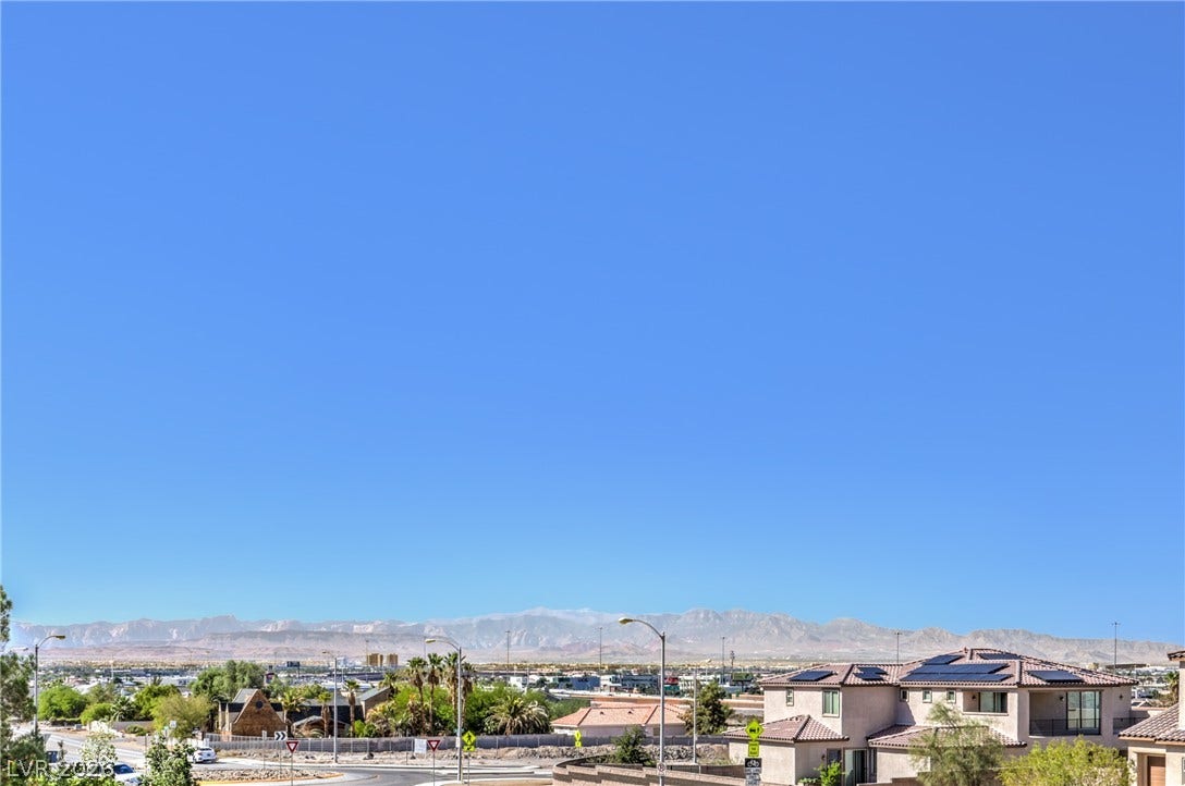 3051 E Serene Avenue, Henderson, NV 89074 Distant mountain ranges form a dramatic backdrop under a vast clear blue sky.