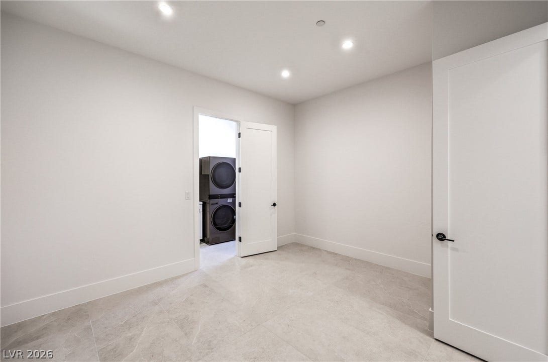 3051 E Serene Avenue, Henderson, NV 89074 Recessed lighting illuminates this versatile utility space featuring sleek tiled flooring and clean lines.