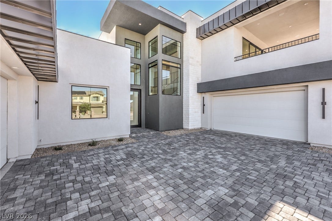 3051 E Serene Avenue, Henderson, NV 89074 Bold geometric lines and a paved courtyard welcome visitors to this modern exterior.