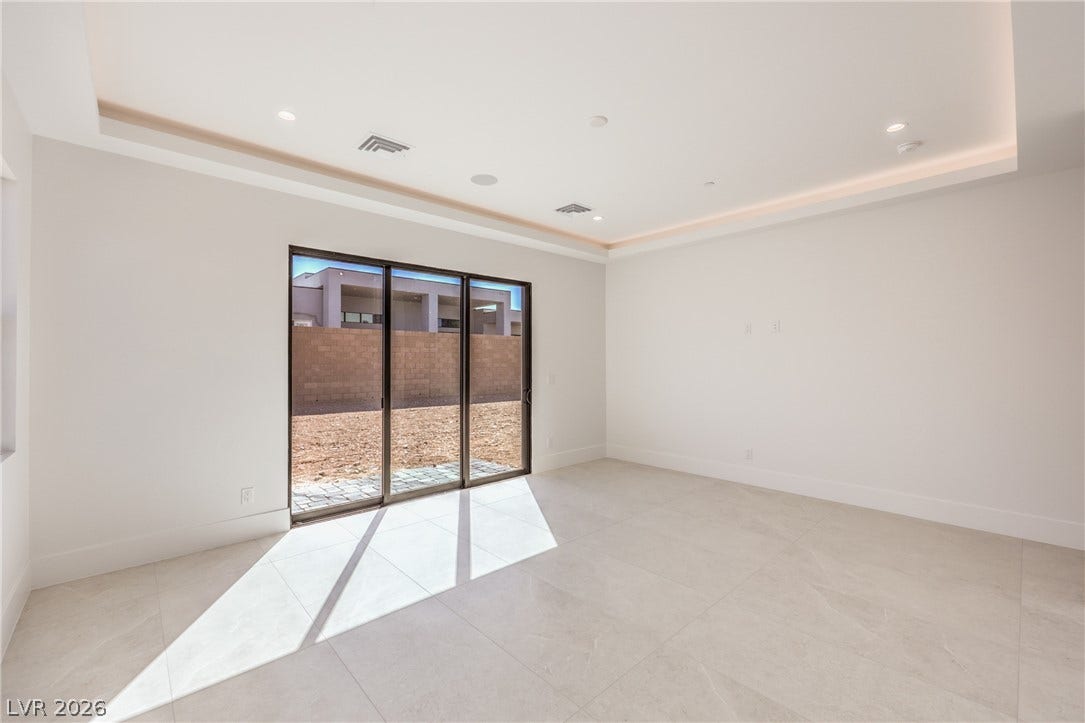 3051 E Serene Avenue, Henderson, NV 89074 Gleaming tile floors and a recessed ceiling accent this sun-drenched space with sliding doors.