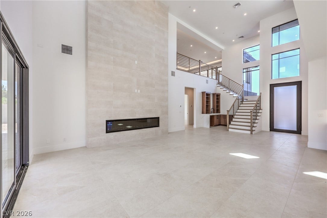 3051 E Serene Avenue, Henderson, NV 89074 A soaring tile fireplace wall serves as the focal point of this open living space.