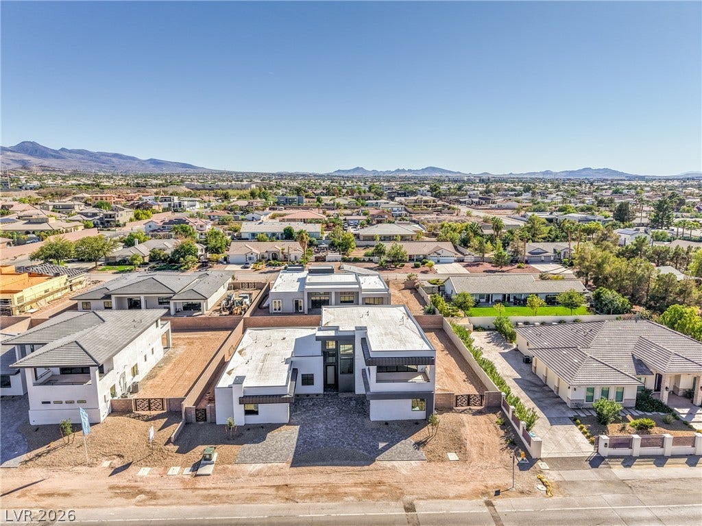 3051 E Serene Avenue, Henderson, NV 89074 Striking contemporary architecture stands out against a backdrop of distant mountains and clear desert skies.