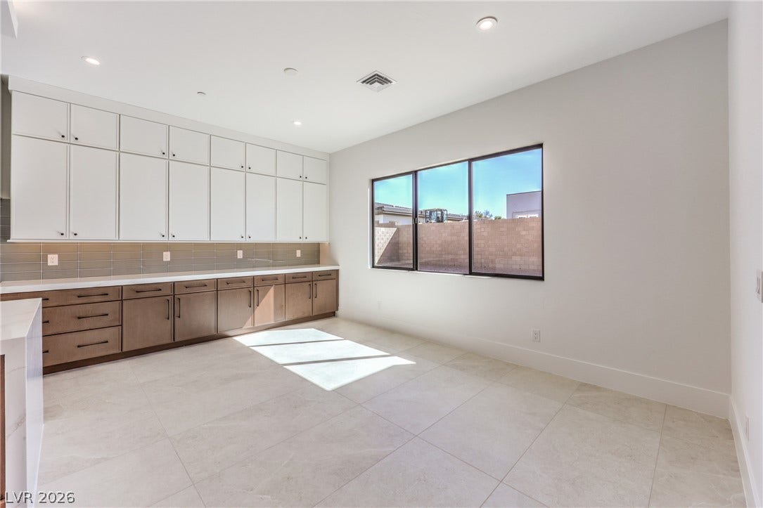 3051 E Serene Avenue, Henderson, NV 89074 Ample built-in cabinetry and stone tile flooring define this versatile service or utility space.