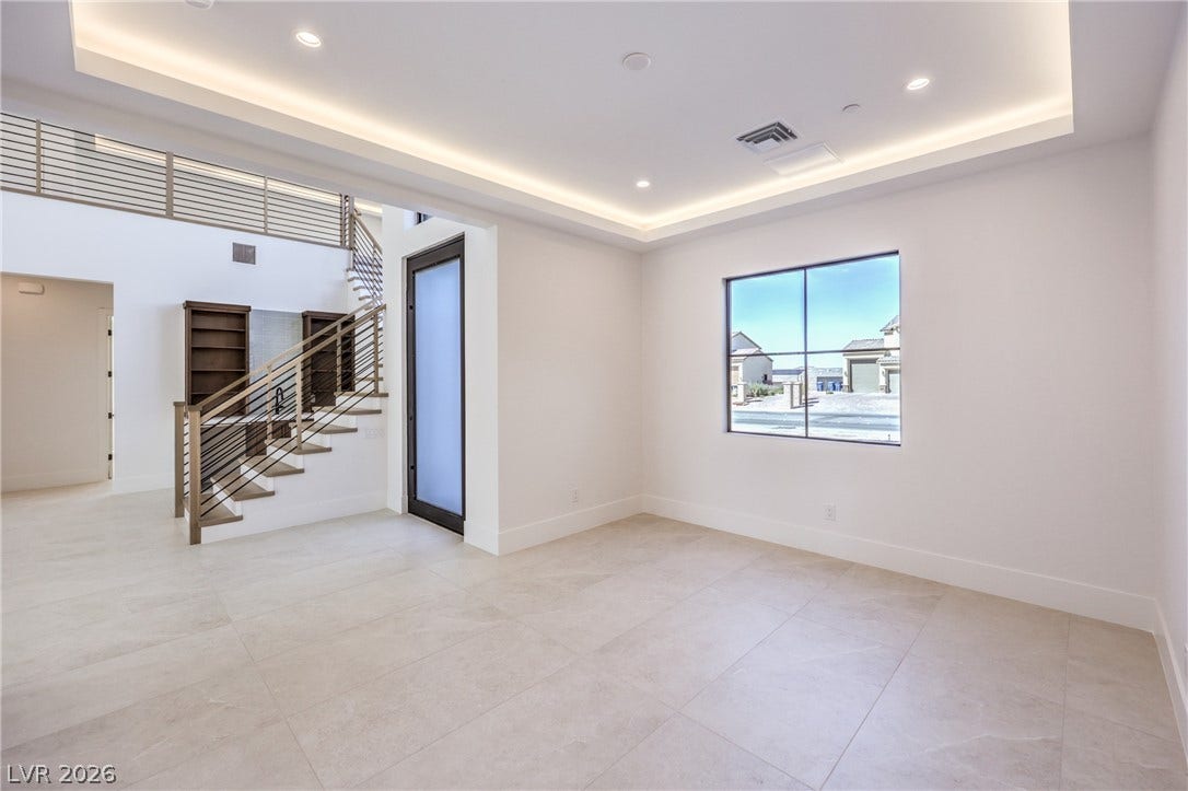 3051 E Serene Avenue, Henderson, NV 89074 Clean lines and stone tile flooring define this airy entryway featuring modern tray ceilings.