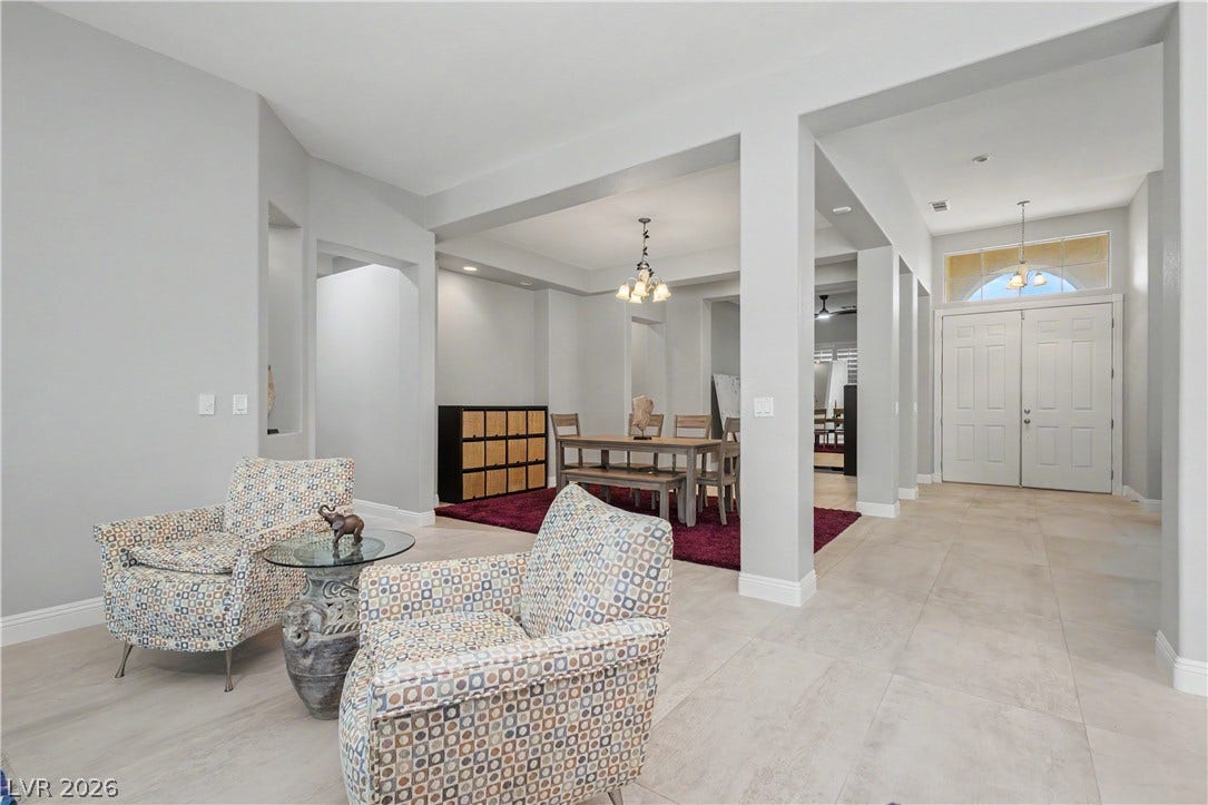 7126 Spindle Berry Street, Las Vegas, NV 89131 Gleaming tile floors flow seamlessly through this open layout leading to a grand double-door entry.