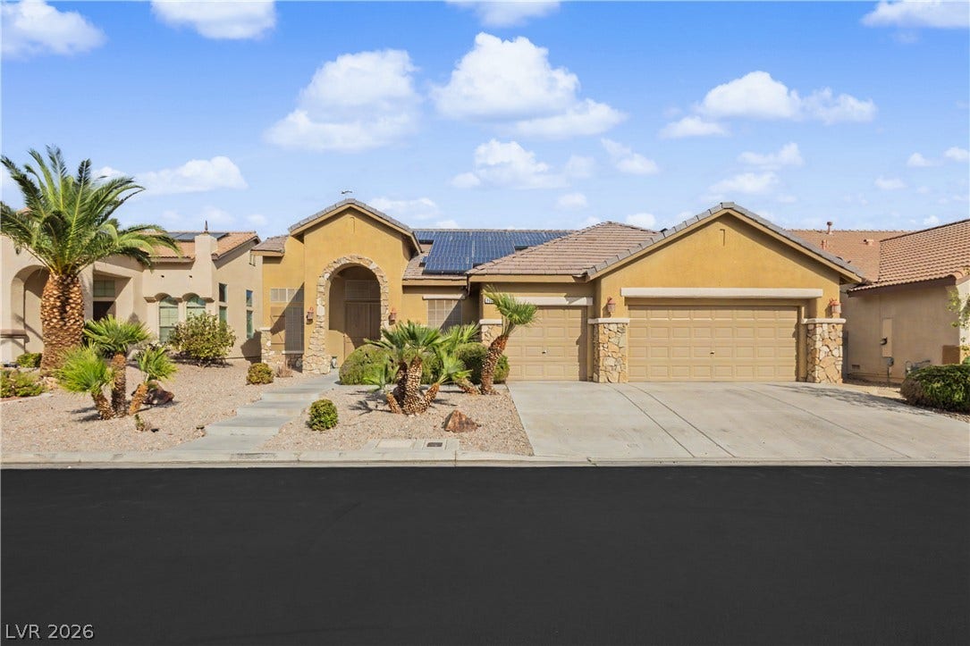 7126 Spindle Berry Street, Las Vegas, NV 89131 Desert landscaping and stone accents frame this classic Southwestern-style residence.