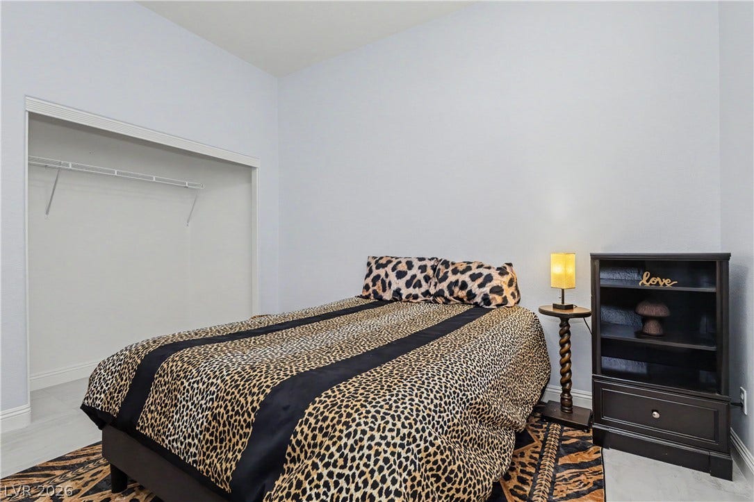 7126 Spindle Berry Street, Las Vegas, NV 89131 High ceilings and neutral walls frame this versatile bedroom space.
