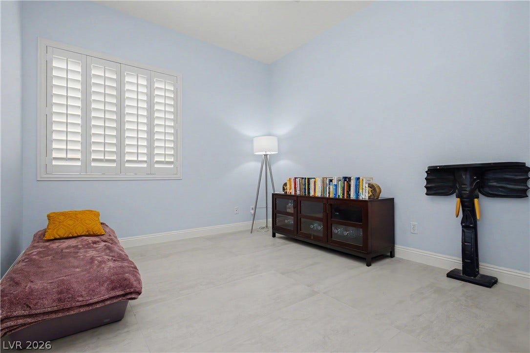 7126 Spindle Berry Street, Las Vegas, NV 89131 Crisp plantation shutters and durable tile flooring define this versatile secondary bedroom space.