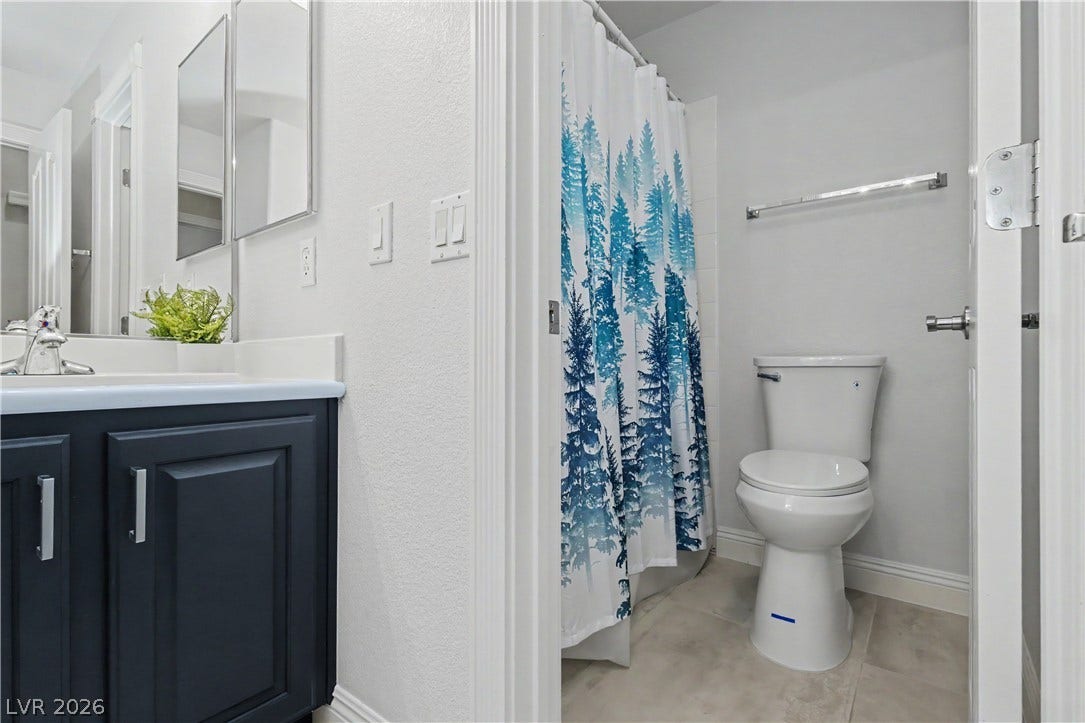7126 Spindle Berry Street, Las Vegas, NV 89131 Crisp finishes and tile flooring define this smartly configured bath.