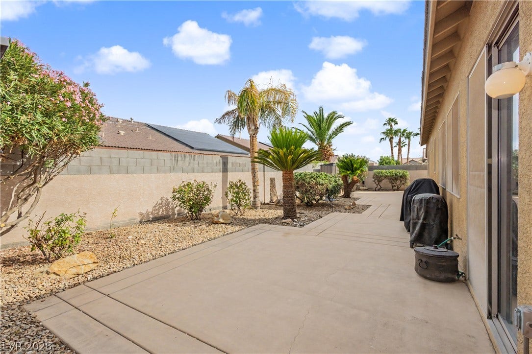 7126 Spindle Berry Street, Las Vegas, NV 89131 A spacious concrete patio borders low-maintenance desert landscaping framed by a sturdy block wall.