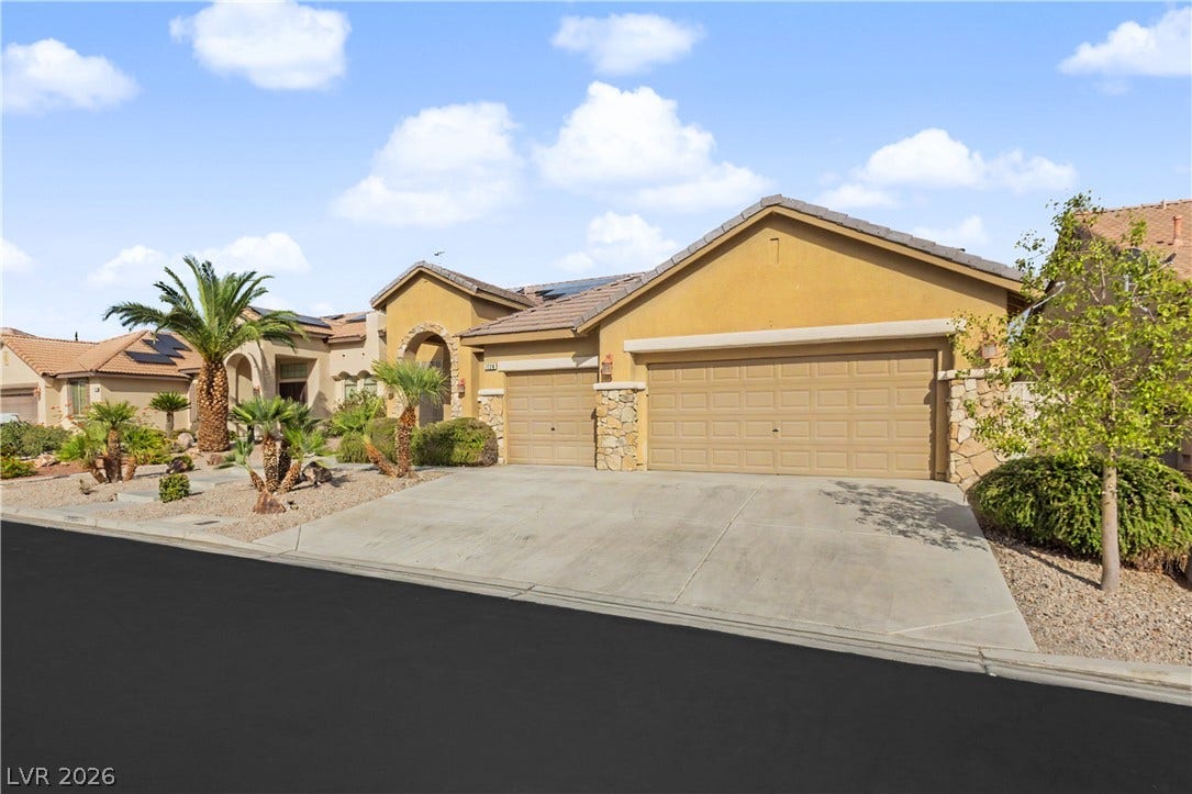 7126 Spindle Berry Street, Las Vegas, NV 89131 Desert landscaping and stone accents frame this classic stucco home with a spacious driveway.