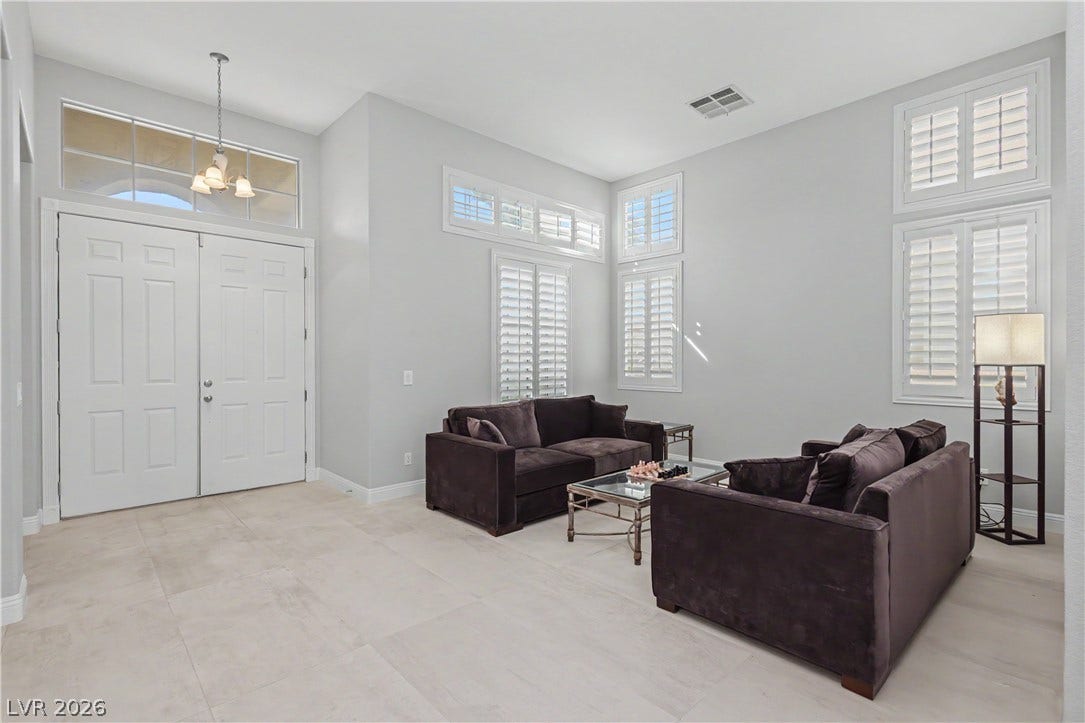 7126 Spindle Berry Street, Las Vegas, NV 89131 Gleaming tile floors and soaring high ceilings define this welcoming front entryway and seating space.
