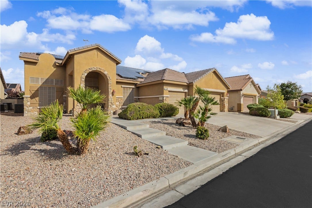 7126 Spindle Berry Street, Las Vegas, NV 89131 Desert landscaping and a stone-accented archway create immediate curb appeal for this single-level home.
