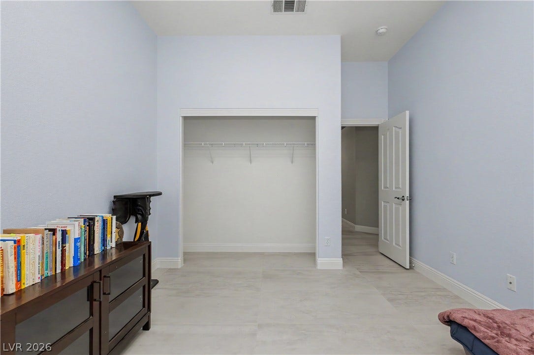 7126 Spindle Berry Street, Las Vegas, NV 89131 High ceilings and durable tile flooring highlight this versatile secondary bedroom space.