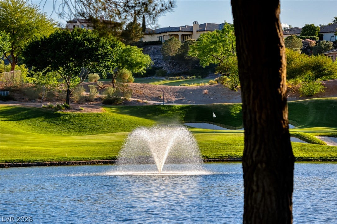 A sparkling water fountain anchors this scenic view across the manicured fairway.