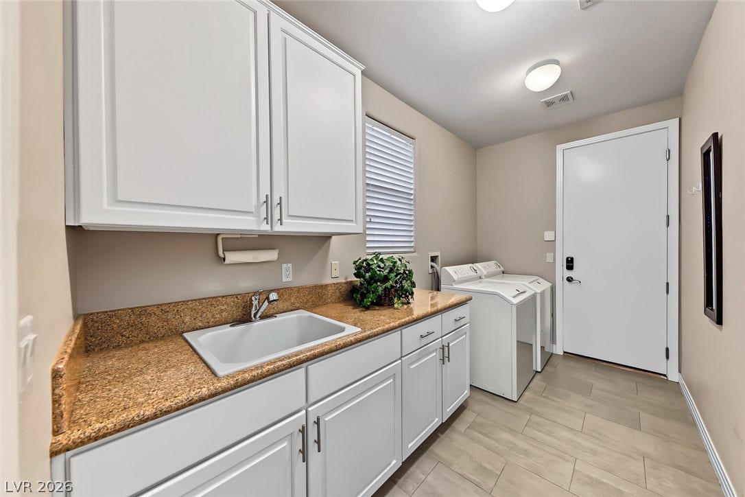 Functional workspace features durable tile flooring and plenty of built-in cabinet storage.