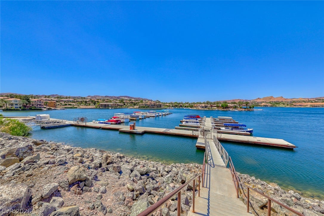 Private community docks offer direct access to serene lake waters under clear blue skies.