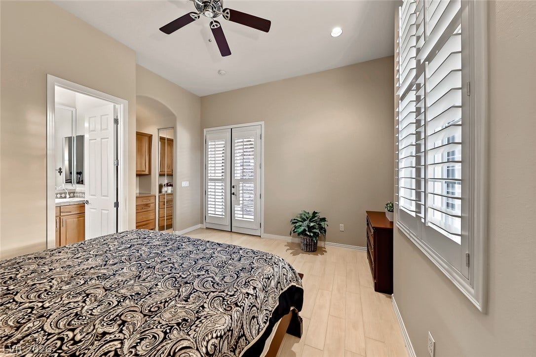 Gleaming hardwood floors and classic plantation shutters define this inviting bedroom retreat.