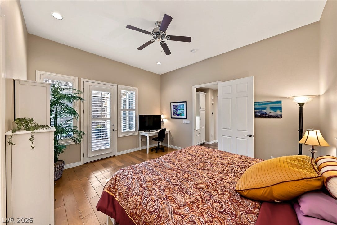Gleaming hardwood floors and a bright glass door elevate this tranquil bedroom retreat.