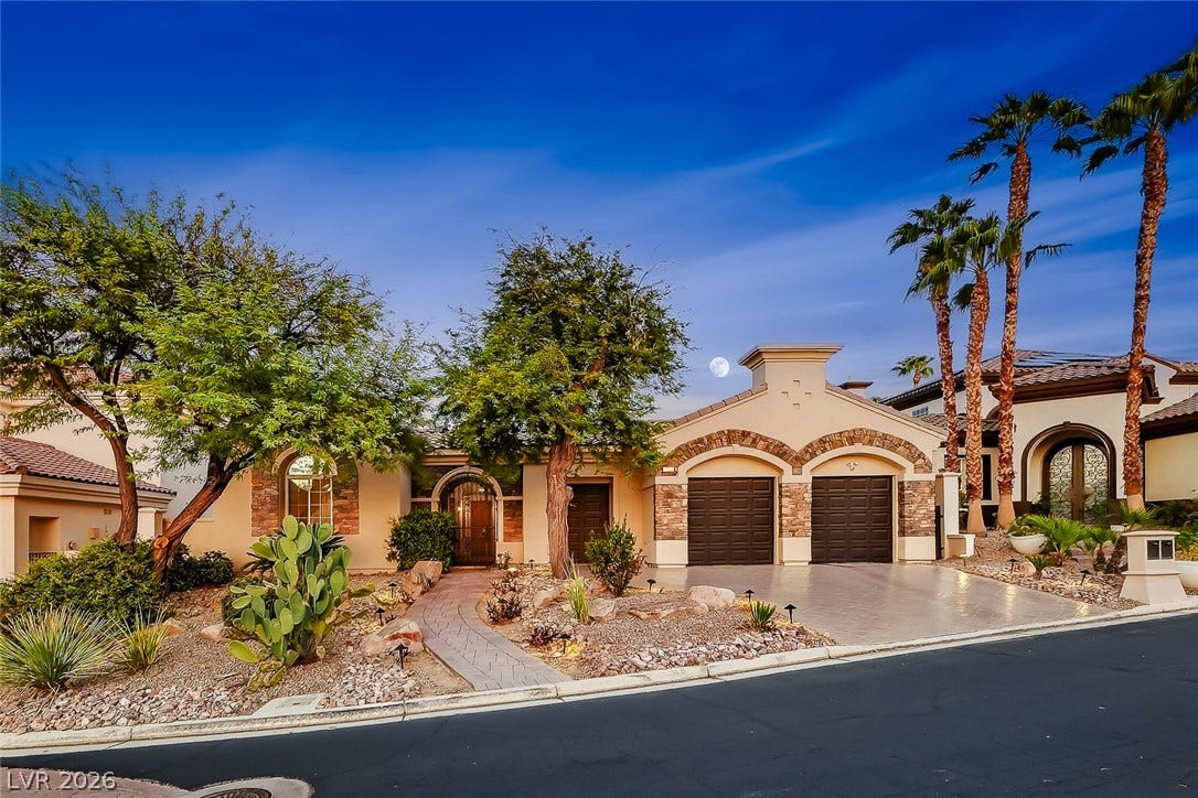 Distinctive desert landscaping and textured stone accents elevate this elegant exterior facade.