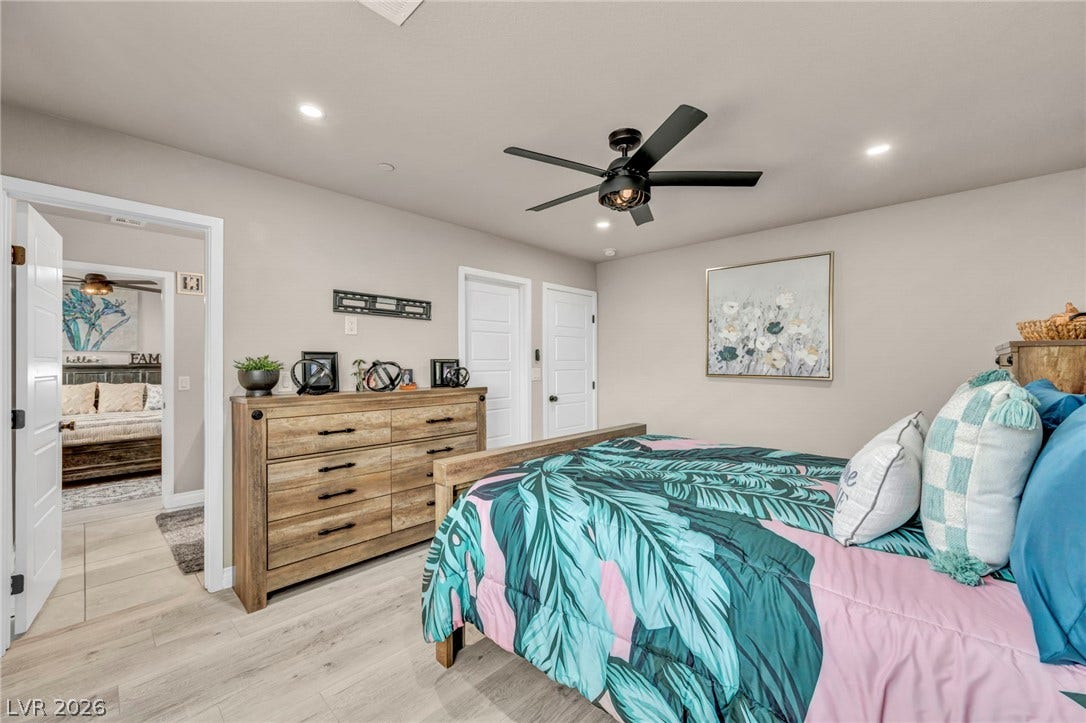 7481 Garnet Moon Street, North Las Vegas, NV 89084 Smooth wood-look flooring and clean architectural lines define this welcoming private retreat.