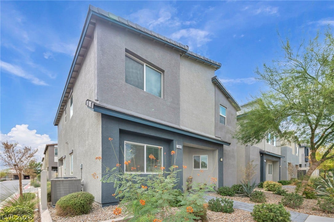 7481 Garnet Moon Street, North Las Vegas, NV 89084 A modern two-story exterior showcases clean architectural lines under a bright desert sky.