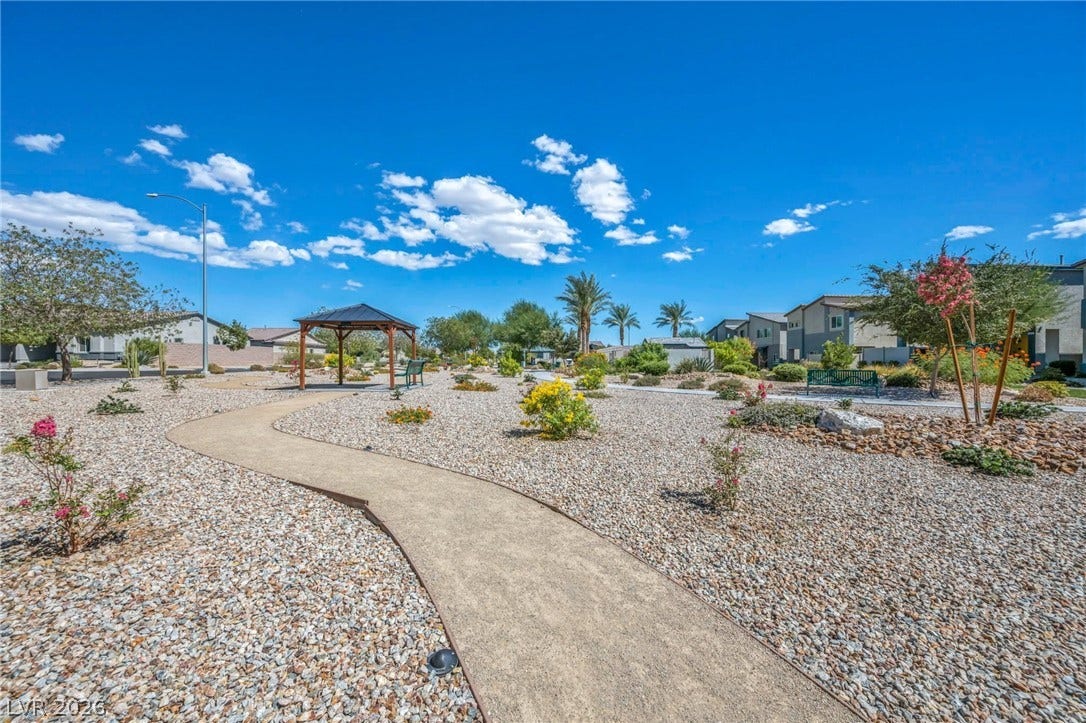 7481 Garnet Moon Street, North Las Vegas, NV 89084 A winding paved walkway meanders through desert landscaping with a gazebo and community benches.