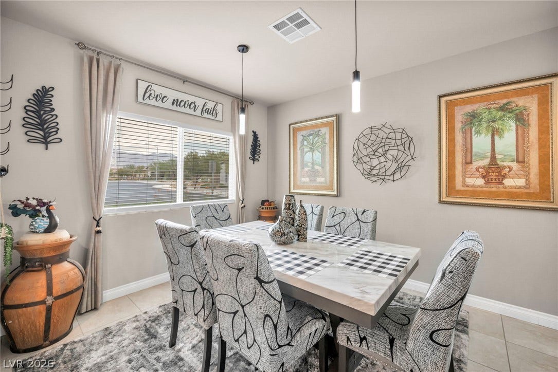 7481 Garnet Moon Street, North Las Vegas, NV 89084 Natural light fills this inviting dining area finished with sleek tile flooring.