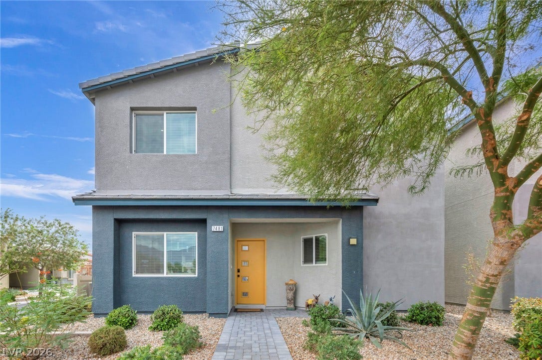 7481 Garnet Moon Street, North Las Vegas, NV 89084 Desert landscaping and a paved walkway lead to a modern two-story exterior with a bright entry door.