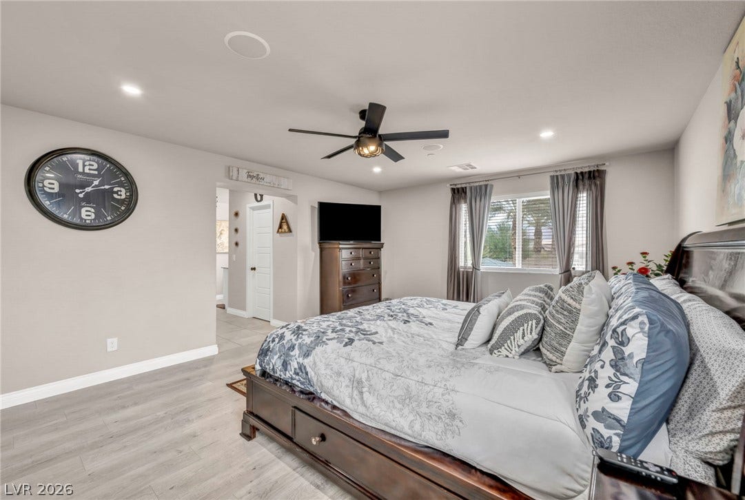 7481 Garnet Moon Street, North Las Vegas, NV 89084 Recessed lighting and wood-look flooring enhance this comfortable bedroom layout.