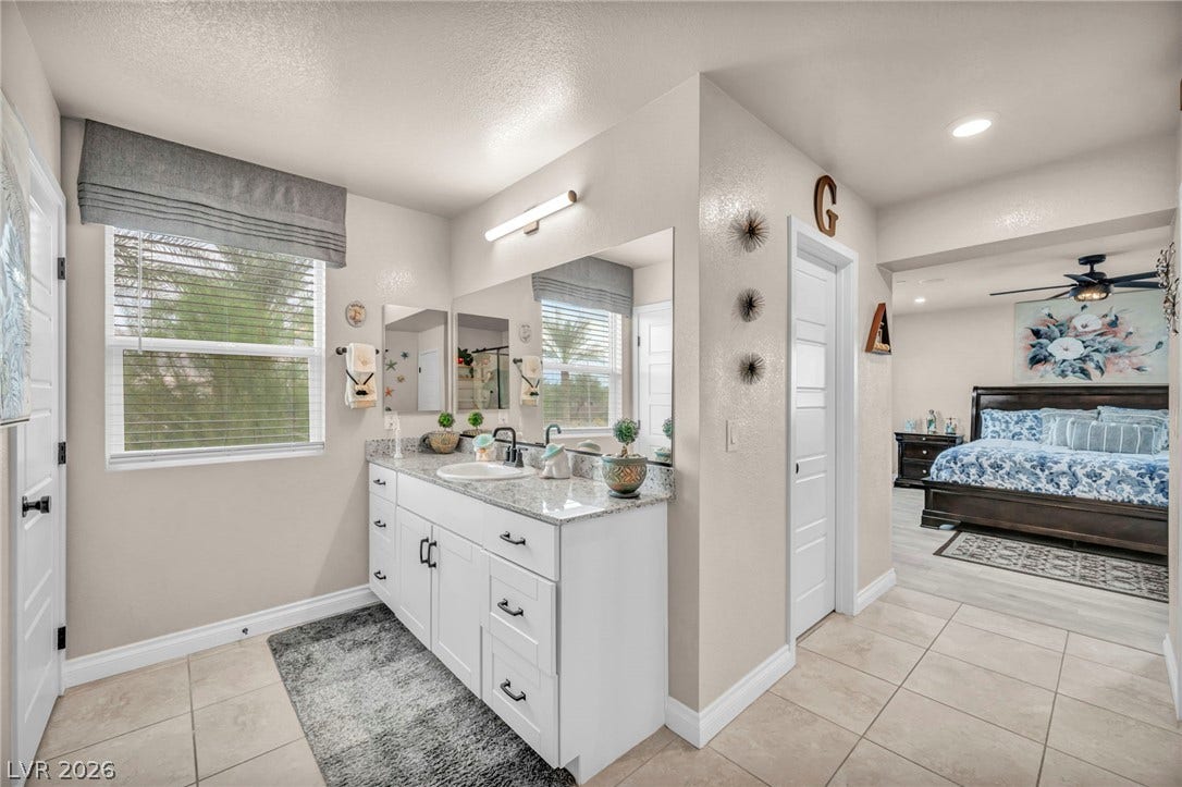 7481 Garnet Moon Street, North Las Vegas, NV 89084 A well-appointed vanity features stone countertops and connects seamlessly to the main bedroom suite.