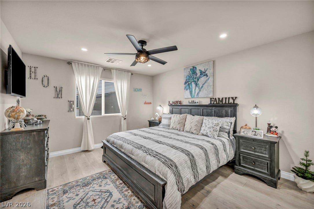7481 Garnet Moon Street, North Las Vegas, NV 89084 Smooth wood-look flooring and recessed lighting define this inviting bedroom space.