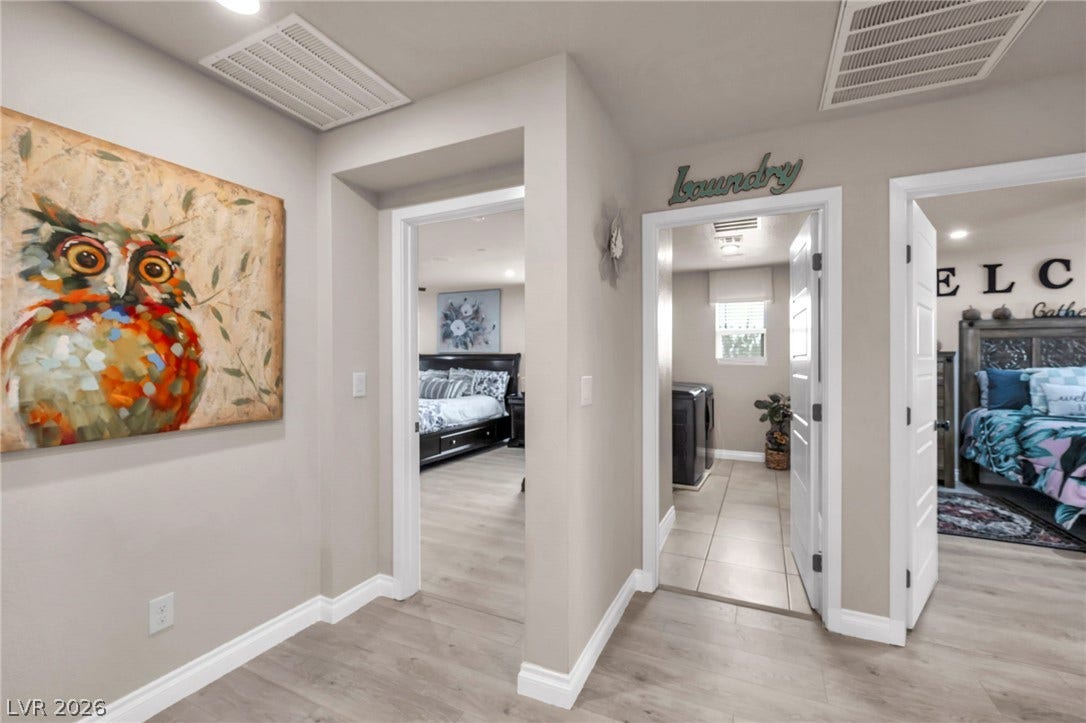 7481 Garnet Moon Street, North Las Vegas, NV 89084 Smooth wood-look flooring and crisp trim connect multiple rooms along this central hallway.