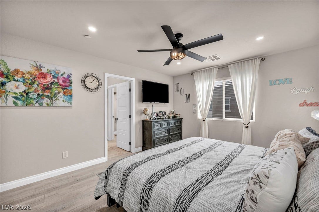 7481 Garnet Moon Street, North Las Vegas, NV 89084 Smooth wood-style flooring and recessed lighting set a serene tone in this comfortable bedroom.