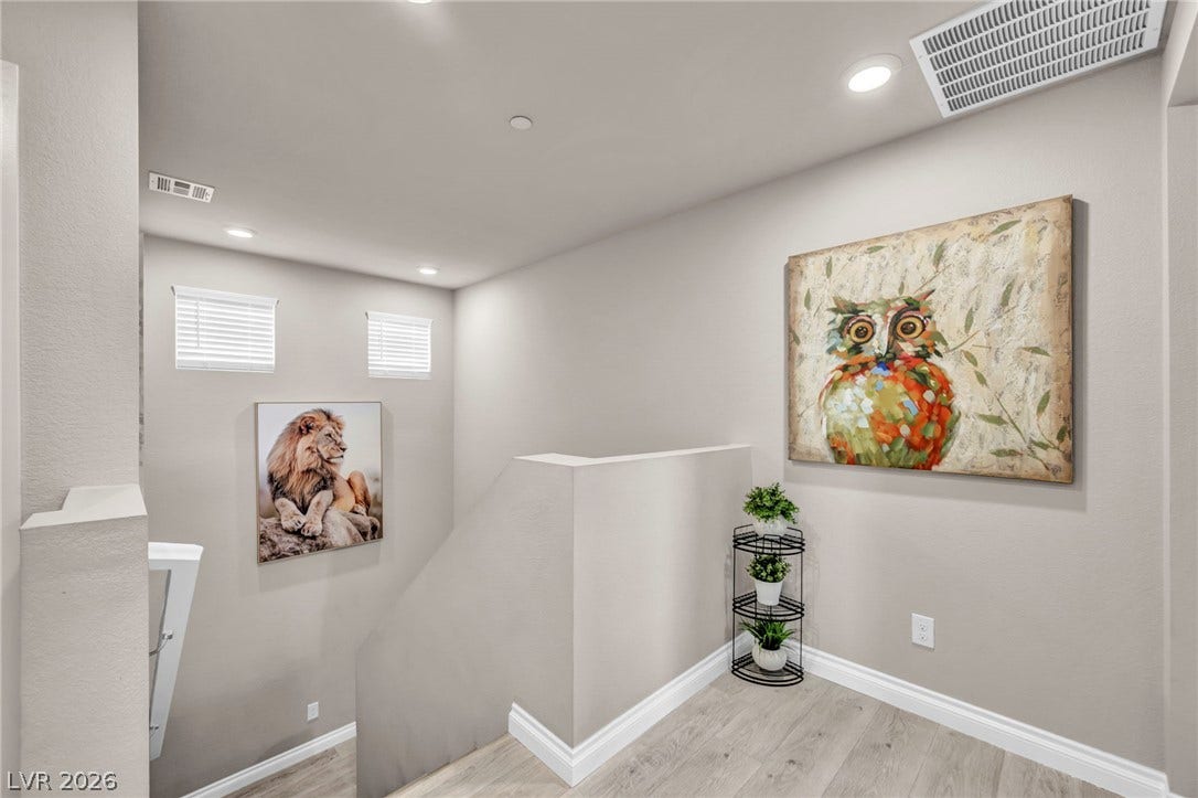 7481 Garnet Moon Street, North Las Vegas, NV 89084 Recessed lighting and wood-look flooring enhance this inviting upper landing area.