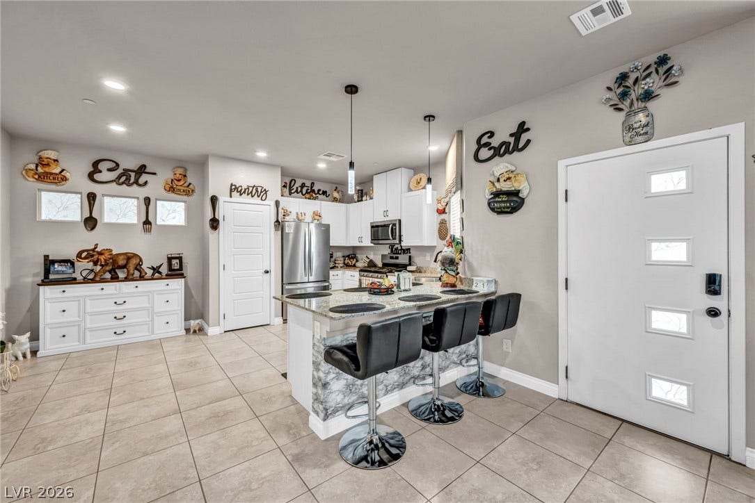 7481 Garnet Moon Street, North Las Vegas, NV 89084 An open kitchen layout flows seamlessly into the main living spaces over durable tile flooring.
