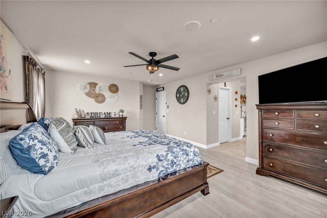 7481 Garnet Moon Street, North Las Vegas, NV 89084 Smooth wood-look flooring and recessed lighting define this comfortable, light-filled sleeping space.
