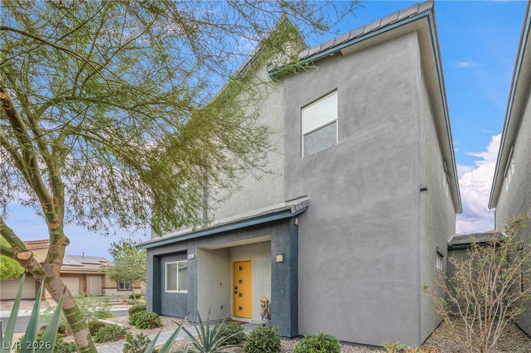 7481 Garnet Moon Street, North Las Vegas, NV 89084 Modern multi-level exterior architecture features clean stucco finishes under a contrasting tile roof line.