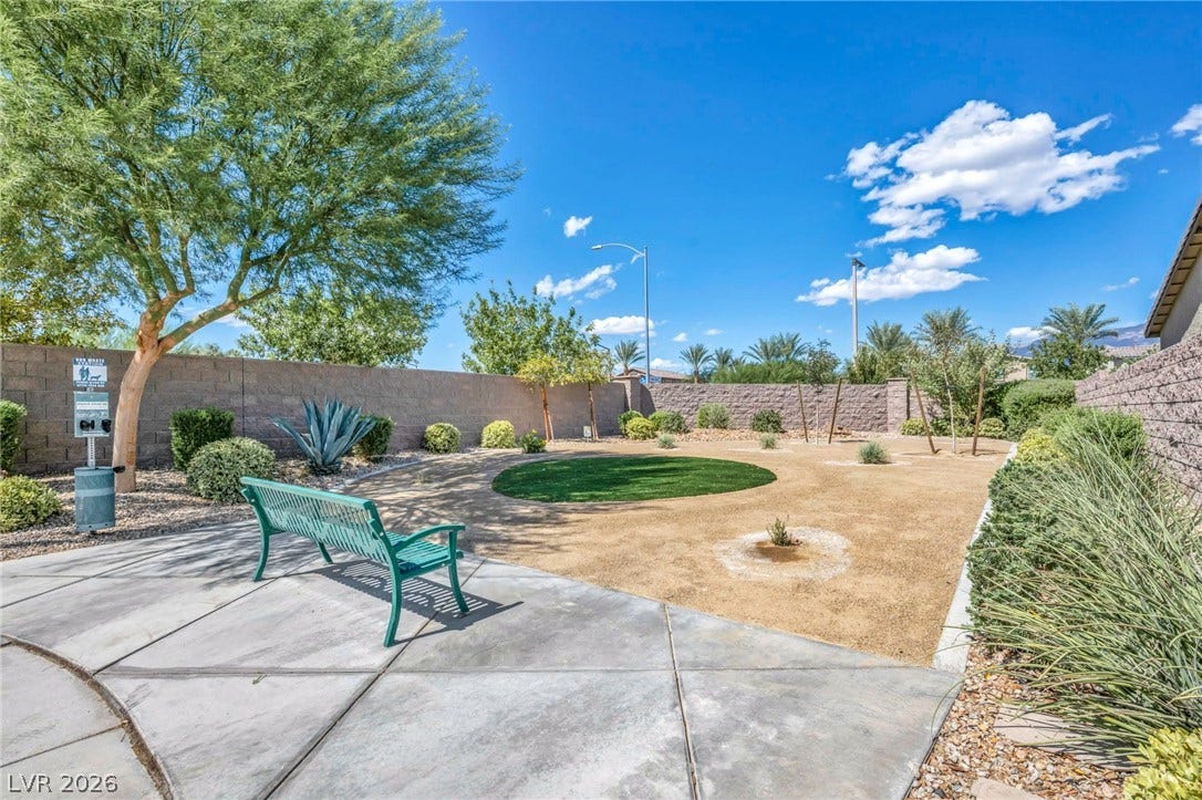 7481 Garnet Moon Street, North Las Vegas, NV 89084 Fenced community park space features low-maintenance desert landscaping under wide blue skies.