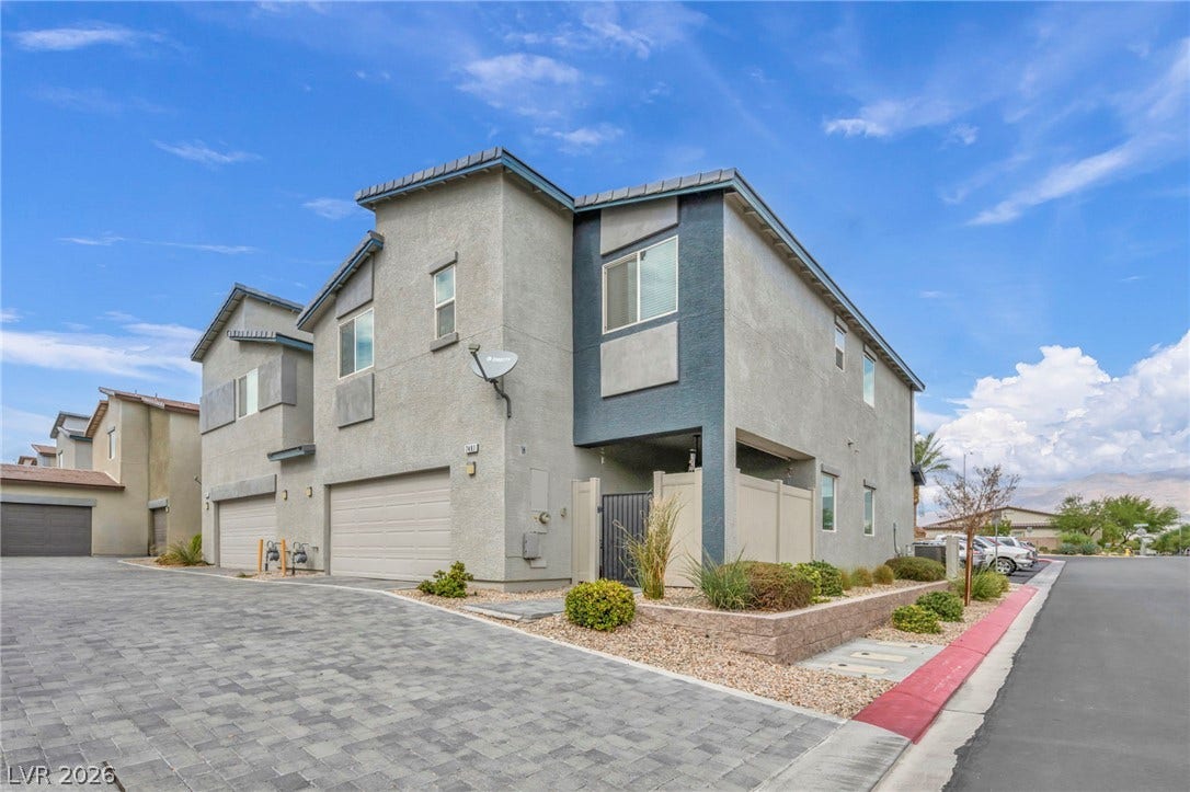 7481 Garnet Moon Street, North Las Vegas, NV 89084 A modern multi-level exterior displays clean stucco finishes alongside an integrated two-car garage.