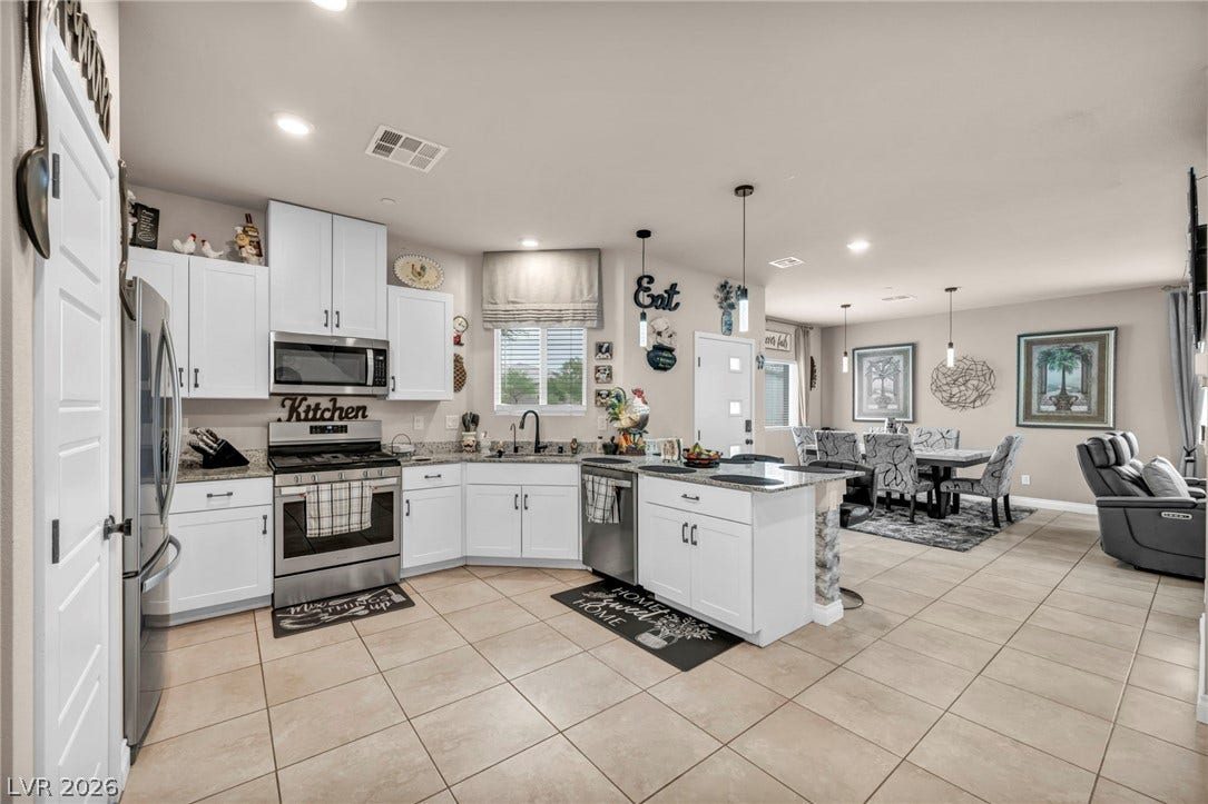 7481 Garnet Moon Street, North Las Vegas, NV 89084 An open floorplan seamlessly connects the well-equipped kitchen with the adjacent dining area.