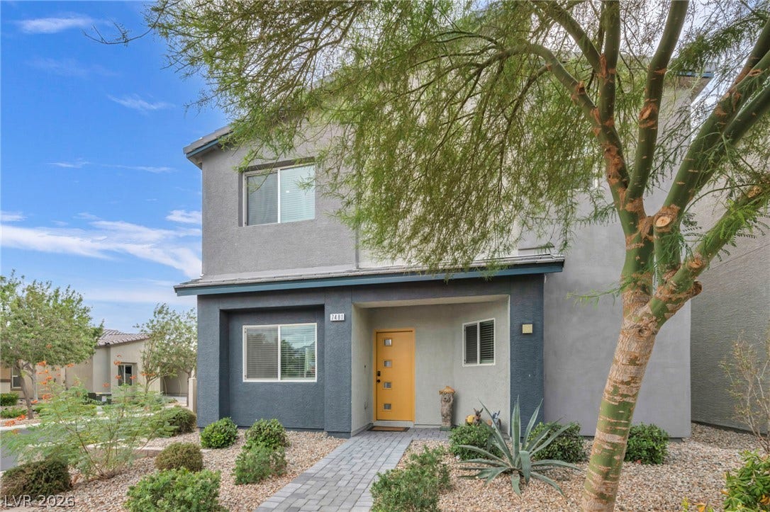 7481 Garnet Moon Street, North Las Vegas, NV 89084 A paved walkway leads past desert landscaping to the inviting front entrance of this modern home.