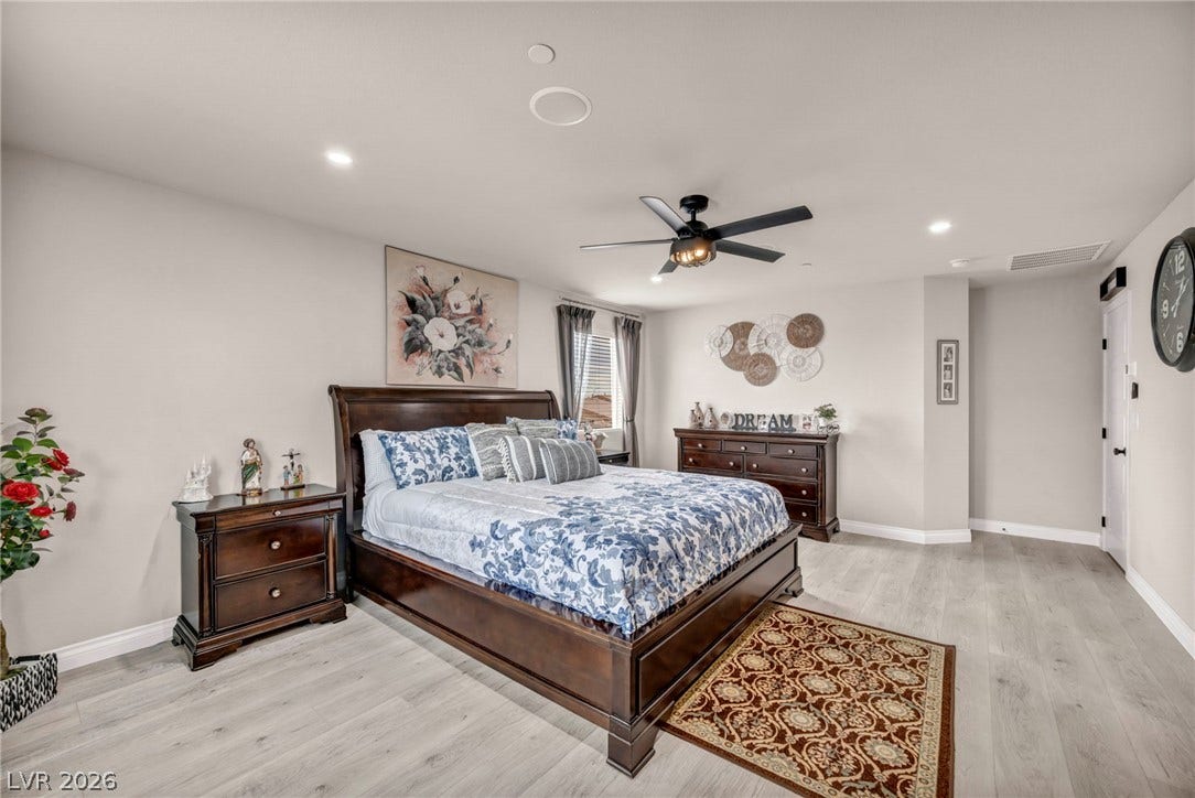 7481 Garnet Moon Street, North Las Vegas, NV 89084 Recessed lighting and wood-inspired flooring elevate this tranquil bedroom retreat.