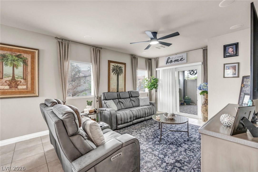 7481 Garnet Moon Street, North Las Vegas, NV 89084 Tiled flooring and sliding glass doors leading outside define this comfortable living space.