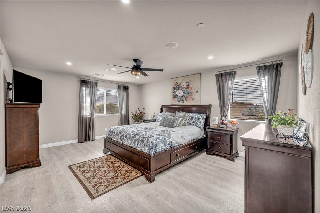 7481 Garnet Moon Street, North Las Vegas, NV 89084 Recessed lighting and wood-inspired flooring elevate this comfortable master bedroom retreat.