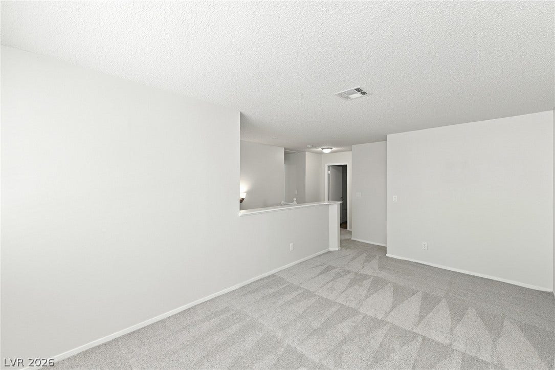 378 Tierra Street, Henderson, NV 89014 An open upstairs loft area features wall-to-wall carpeting and neutral walls.