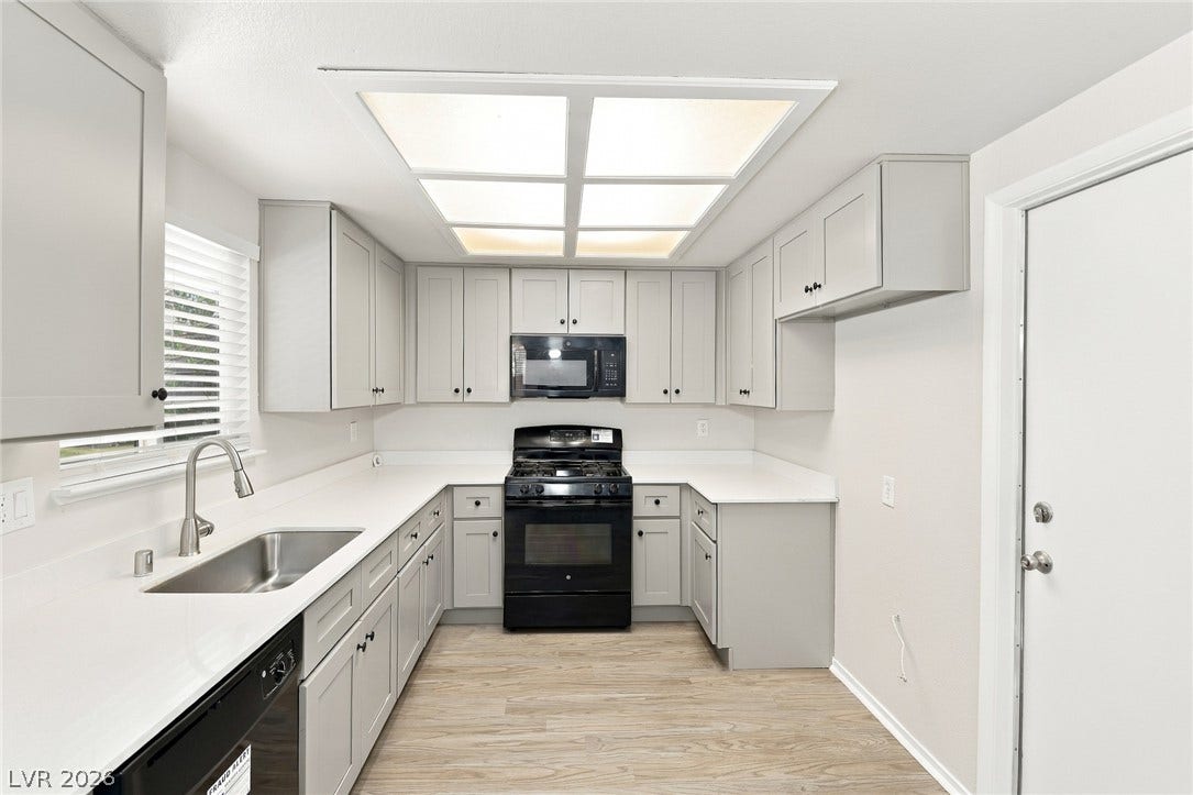 378 Tierra Street, Henderson, NV 89014 Gleaming stone countertops and shaker cabinetry define this modern, efficiently designed workspace.