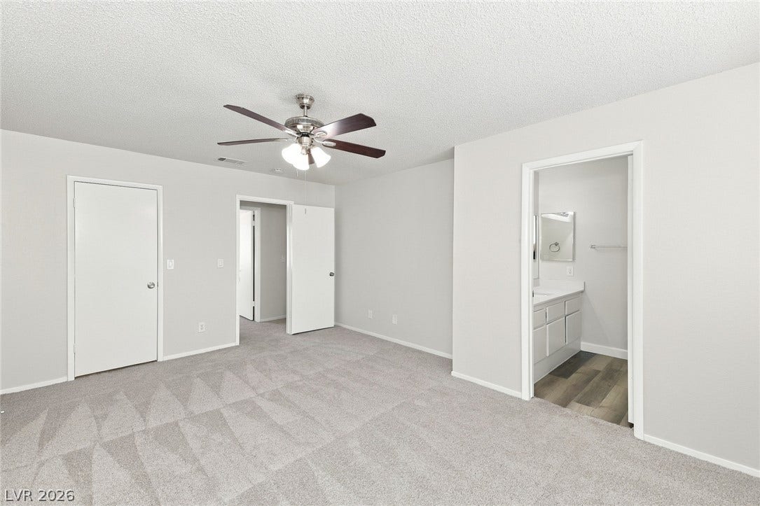 378 Tierra Street, Henderson, NV 89014 Soft carpeting underfoot anchors this quiet bedroom suite with access to a private bathroom.