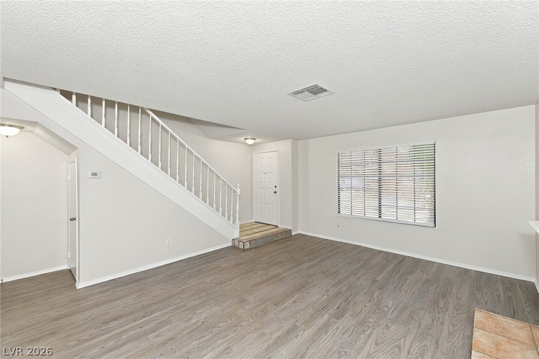 378 Tierra Street, Henderson, NV 89014 Smooth wood-look flooring and an elegant staircase define this open living space.